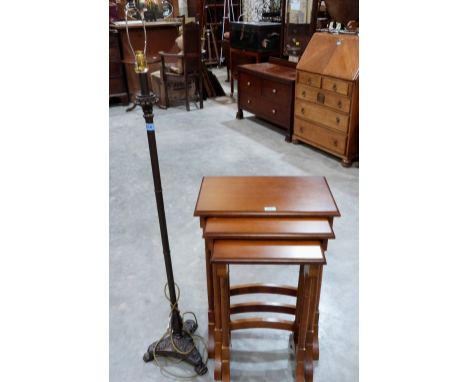 A nest of three occasional tables and a metal lamp standard