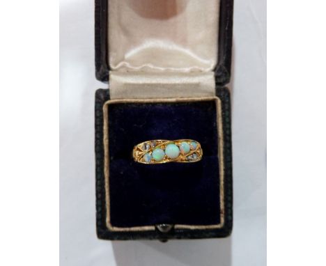 A five stone opal ring. In gold marked 18. Size O. 2.8g gross 