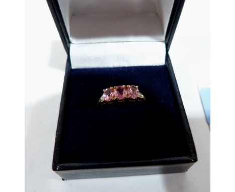 A pink tourmaline three stone ring. In gold marked 750. Size Q. 2.7g gross 