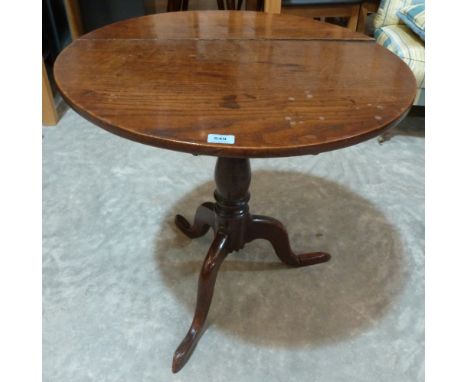 A 19th century oak snap-top table, the round top on baluster column and tripod support. 28' diam. One foot repaired 