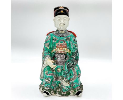 Detailed ceramic figure of a deity seated wearing court robes decorated with a phoenix badge amongst clouds and various hand 