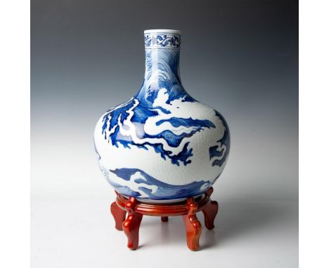 This beautiful porcelain vase features reverse hand-painted artistry, with the background meticulously detailed and the drago