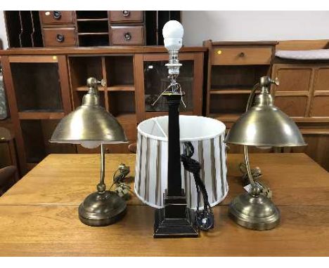 A pair of contemporary brass finished desk tamps together with a table lamp with shade