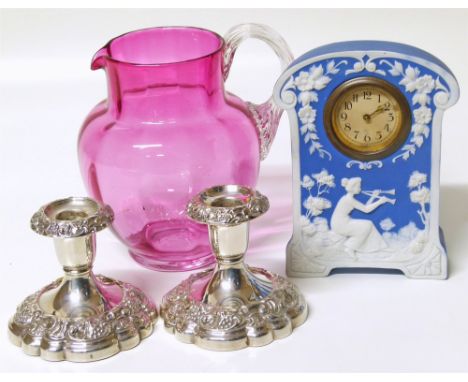A pair of plated candlesticks, Wedgwood style fronted pottery mantle clock and cranberry glass jug Condition reports are not 