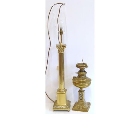 Two large brass lamps, one a corinthian column lamp (converted for electricity), and an oil lamp base with metal fretwork wit
