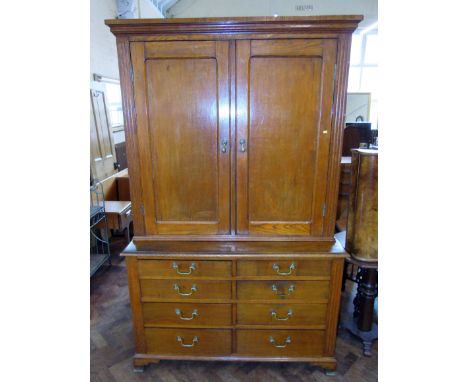 Late Victorian oak two door cupboard on base with eight graduated drawers, 128 wide x 204cm tall. Condition reports are not a