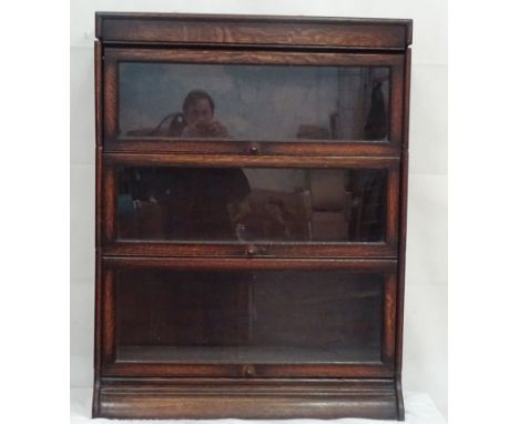 A three-section oak Globe Wernicke-style bookcase