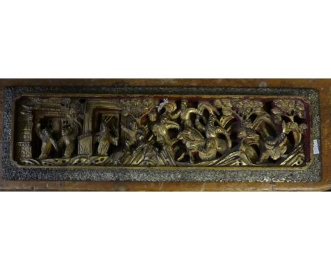 A 20th Century Oriental hardwood pierced and gilt panel decorated with various figures      CONDITION REPORT:  Some slight da