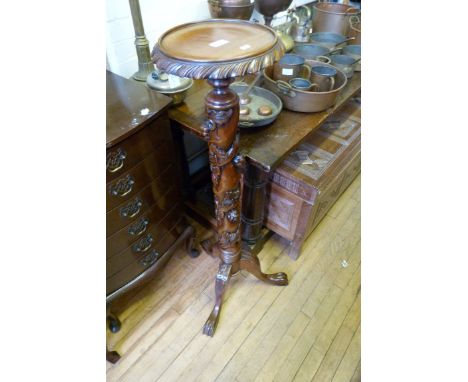An Oriental hardwood carved planter on tripod base.