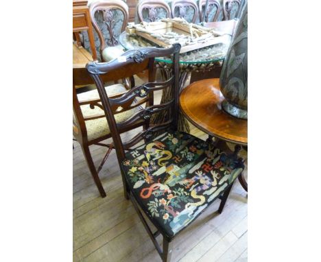 A 19th Century mahogany ladder back dining chair with needlework upholstery.
