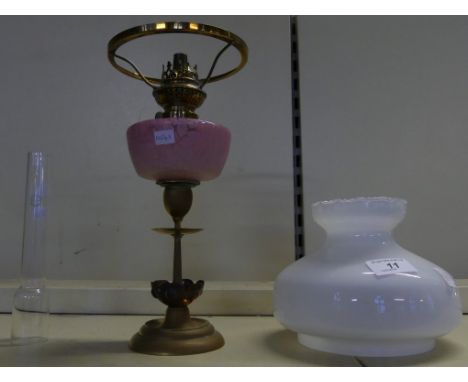 A small late 19th Century oil lamp with frosted pink glass font and opaque white glass shade 