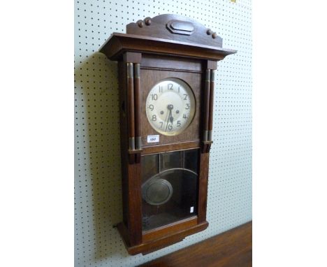 A 20th Century oak wall clock with silvered dial 