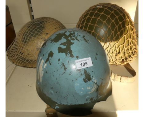 A mixed lot of military helmets comprising two WWII medal helmets and a further replica plastic UN helmet (3)