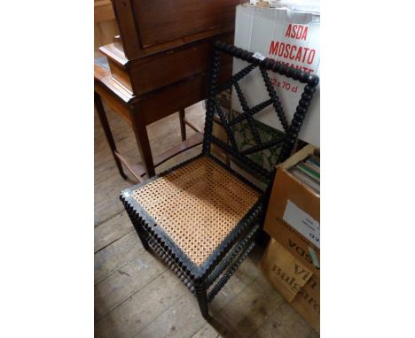 A rattan seated single chair, with bobbin turn back and supports.