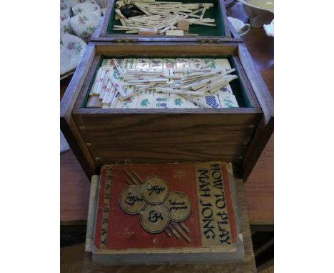 An oak cased Mahjong set and instruction book.   CONDITION REPORT:  147 tiles in totalTiles bamboo and bonesee photos