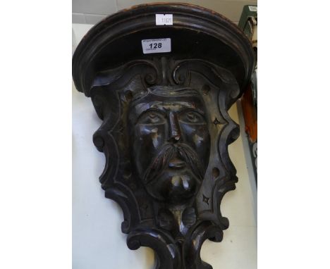 A late 19th/early 20th Century carved hardwood wall bracket decorated with a gentleman's face.