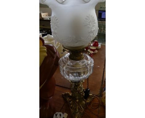 A Victorian brass based oil lamp with later electric conversion (sold electrically untested).                                