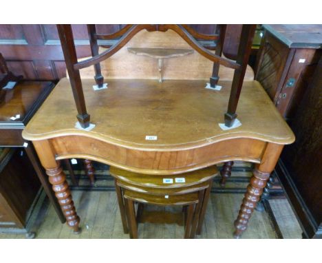 A 19th Century walnut serpentine fronted washstand with back and small shelf unit, raised on bobbin turned supports.