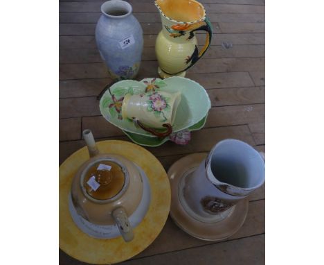 A mixed lot of various assorted ceramics to include various Carltonware floral items, Burleigh ware, serpent handled jug, qua