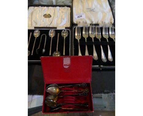 A mixed lot of silver wares comprising a set of silver and black enamel finish coffee spoons, a further cased set of six coff