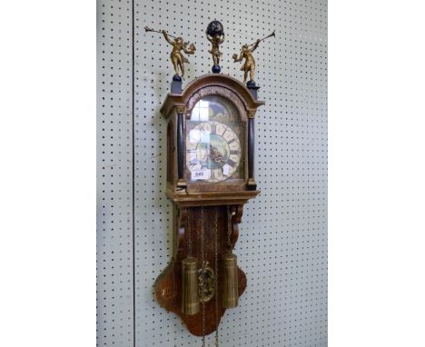 A reproduction wall clock with painted dial, moonphase and two weights.