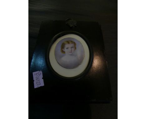 A 19th Century miniature portrait on ivory head and shoulders study of a young girl in ebonised wooden frame.