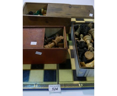 Three boxes of wooden chess pieces and accompanying board.