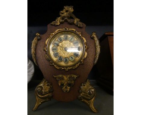 A small early 20th Century Continental mantel clock, in hardwood and gilt metal mounted case.