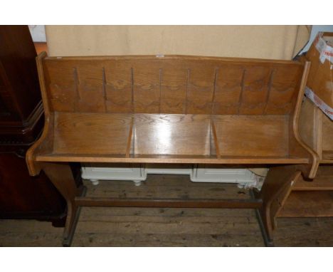 An oak church bookcase/leaflet holder, with three sections for holding hymn books and an array of leaflet compartments.
