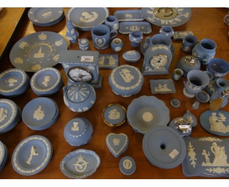 A large mixed lot of modern Wedgwood blue Jasperwares, to include barometer, mantel clock, various vases, commemorative plate