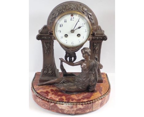 A late 19th century French spelter portico clock with floral decoration and seated maiden on marble base, 34cm tall