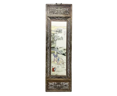 Japanese school framed ceramic panel depicting children in garden scene, signed and inscribed with black script, housed in pi