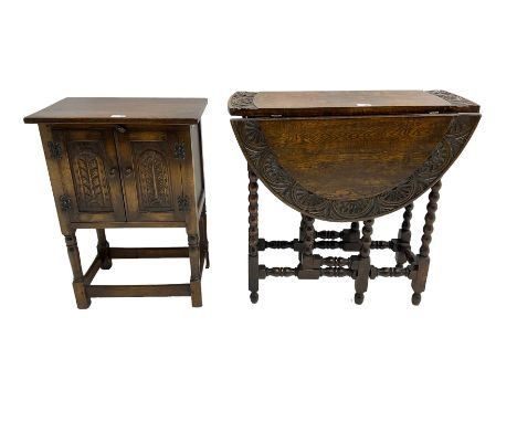 Carved oak drop leaf table, oval top with bobbin turned supports and an oak Hutch cupboard with carved panelled doors (2)