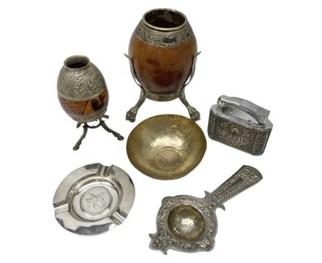 Yerba mate tea gourd calabash cup with silver-plated foliate mounts raised upon three hoof feet, together with silver-plate m