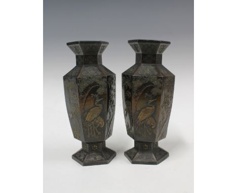 A pair of Japanese bronze patinated metal vases, hexagonal form with relief pattern of storks and other birds with foliage 21