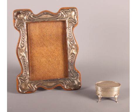 An Edwardian silver mounted photograph frame and a silver ring box with engine turned decoration