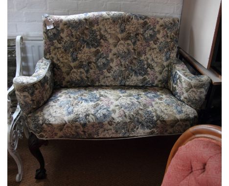 A two-seat settee of early Georgian design, upholstered in a floral tapestry, on cabriole claw and ball supports