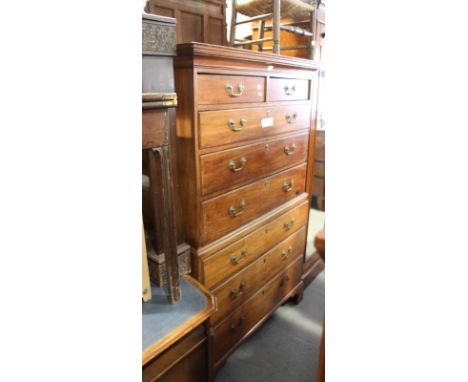 A George III mahogany chest on chest of two short and six long drawers fitted brass loop handles, on bracket supports, 34" wi