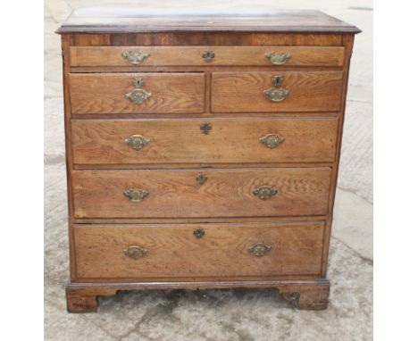 An 18th Century oak and walnut banded chest of one shallow, two small and three long graduated drawers, on bracket supports, 