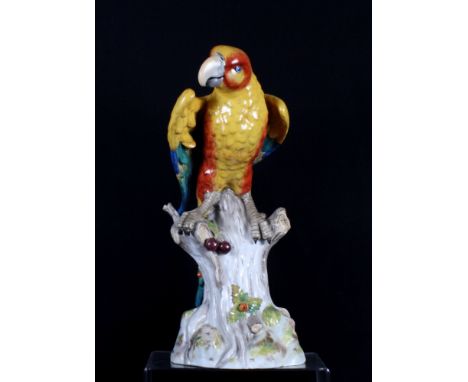 A ceramic model of a parrot on a tree stump, 15" high TAIL RESTORED, and a Portuguese ceramic model of a parrot, 11" high