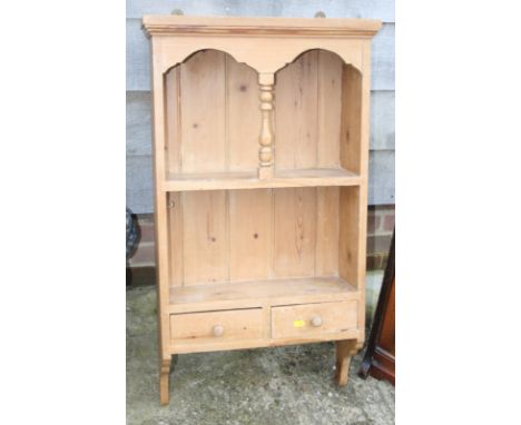 A waxed pine wall hanging shelf, fitted two drawers, 20" wide