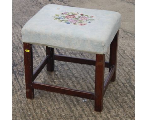 A Georgian mahogany rectangular stool, on square chamfered supports, the stuffed over seat upholstered in a floral tapestry