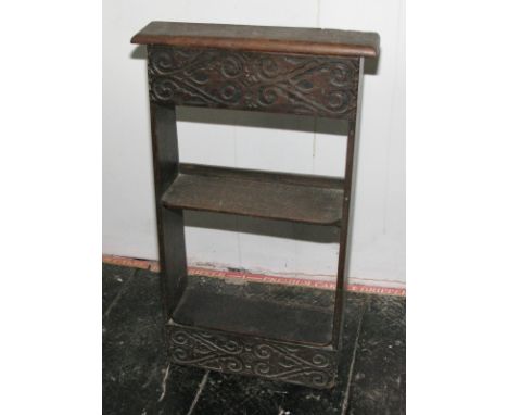 A 17th Century design carved oak three-tier wall shelf/stand with lift-up lid, 16" wide