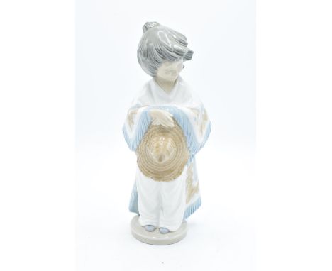 Nao by Lladro unusual figure of a child with a Pancho. In good condition with no obvious damage or restoration. 26cm. 