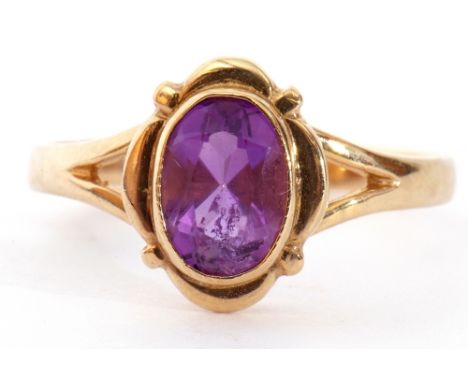 9ct gold amethyst single stone ring, the oval faceted amethyst bezel set between pierced shoulders to a plain shank, size K