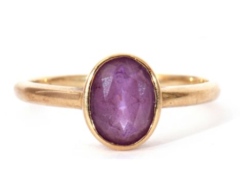 9ct gold amethyst ring, the oval faceted amethyst bezel set in a plain polished mount, size M