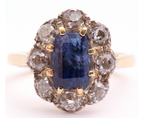 Sapphire and diamond cluster ring, the centre rectangular step cut sapphire 8 x 6mm, surrounded by 8 old cut diamonds, total 