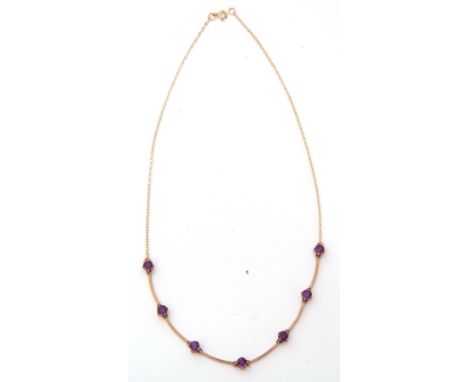 Modern amethyst necklace featuring seven round faceted amethysts, joined by curved bar links to a fine trace chain, stamped 3