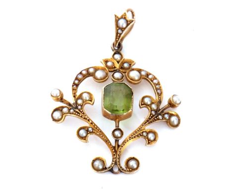 Edwardian open work pendant centring a cushion cut peridot in cut down setting, the scroll frame highlighted throughout with 