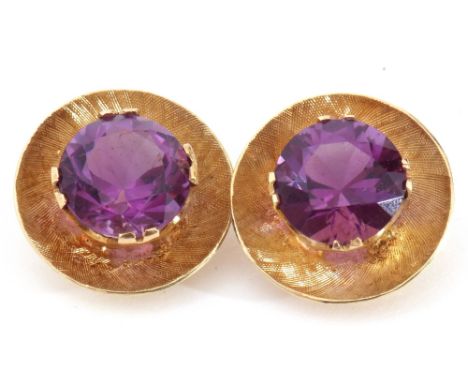 Pair of 585 stamped amethyst earrings, the burnished disc shaped settings each centring a raised round faceted amethyst, 8mm 